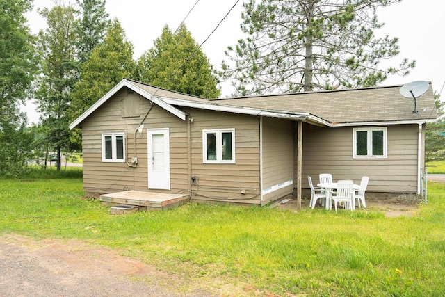 5287 Canosia Rd, Twig, MN 55779 - back of property featuring roof with shingles and a yard