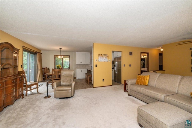 1819 Yosemite Ave, Duluth, MN 55811 - living area with light colored carpet, a textured ceiling, and a chandelier