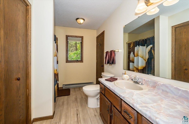 1819 Yosemite Ave, Duluth, MN 55811 - full bathroom featuring baseboard heating, vanity, wood finished floors, a textured ceiling, and curtained shower