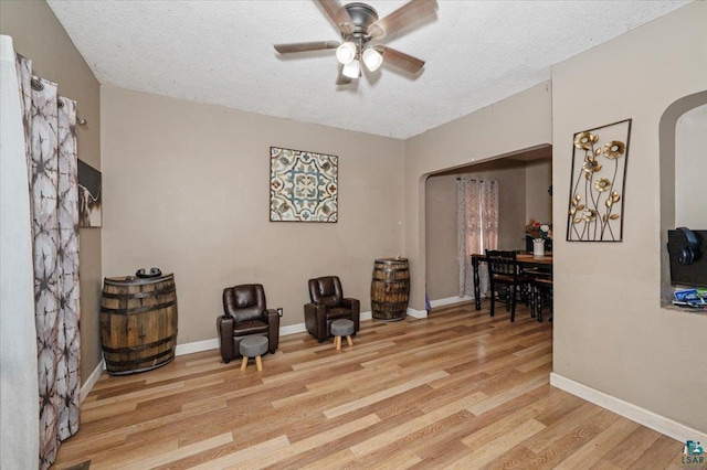 2973 Devonshire St, Duluth, MN 55806 - living area featuring arched walkways, a ceiling fan, light wood-type flooring, and a textured ceiling