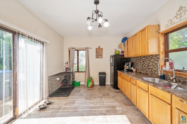 2973 Devonshire St, Duluth, MN 55806 - kitchen with tasteful backsplash, a chandelier, freestanding refrigerator, pendant lighting, and light brown cabinets