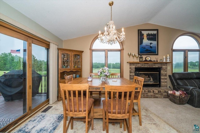 140 E Harney Rd, Esko, MN 55733 - dining space with lofted ceiling, a brick fireplace, a chandelier, and healthy amount of natural light