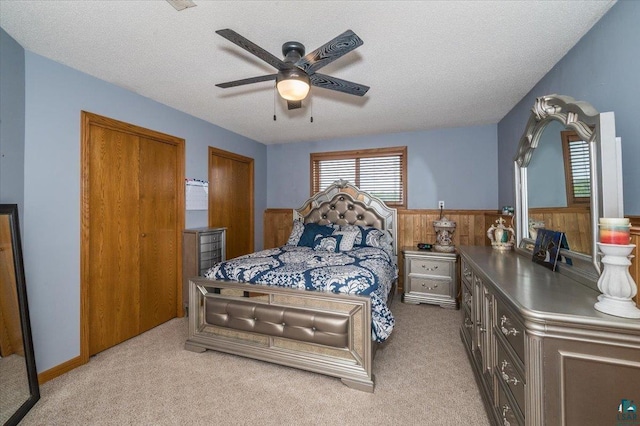 140 E Harney Rd, Esko, MN 55733 - bedroom with wainscoting, carpet, wooden walls, ceiling fan, and a textured ceiling