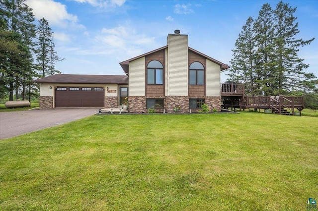 140 E Harney Rd, Esko, MN 55733 - tri-level home with asphalt driveway, an attached garage, a front lawn, a chimney, and a wooden deck