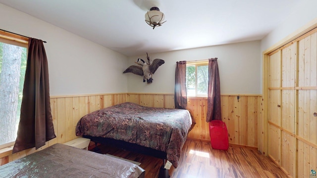 XX3 Sugar Bush Trl, Orr, MN 55771 - bedroom with wainscoting, wood walls, and wood finished floors
