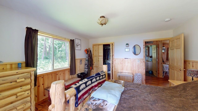 XX3 Sugar Bush Trl, Orr, MN 55771 - bedroom with a wainscoted wall, wooden walls, wood finished floors, and a closet