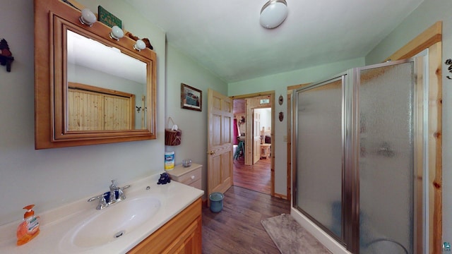 XX3 Sugar Bush Trl, Orr, MN 55771 - full bathroom with vanity, a shower stall, and wood finished floors