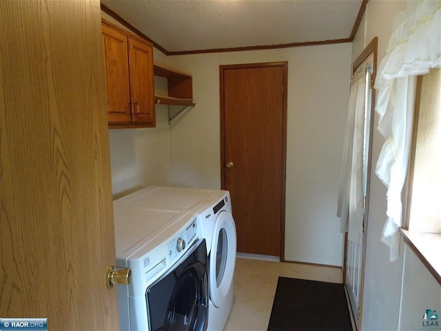 410 S 2nd St, Tower, MN 55790 - laundry area featuring washing machine and clothes dryer, cabinet space, and ornamental molding