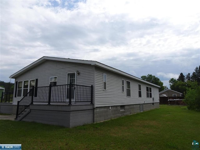 410 S 2nd St, Tower, MN 55790 - view of front facade with a front yard and a wooden deck
