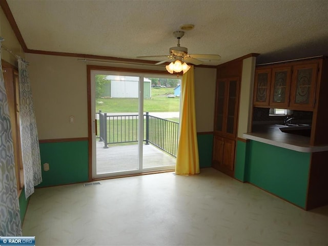 410 S 2nd St, Tower, MN 55790 - kitchen with ceiling fan, a textured ceiling, and crown molding