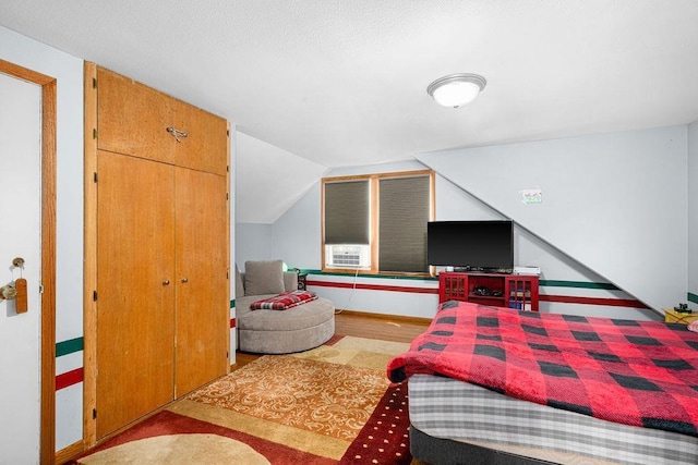 2025 E 8th St, Duluth, MN 55812 - bedroom with vaulted ceiling, wood finished floors, and cooling unit
