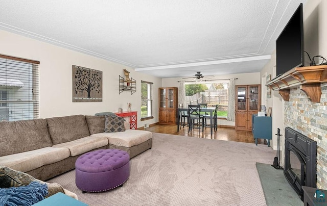 2025 E 8th St, Duluth, MN 55812 - carpeted living room with a fireplace with flush hearth, a ceiling fan, a textured ceiling, and wood finished floors