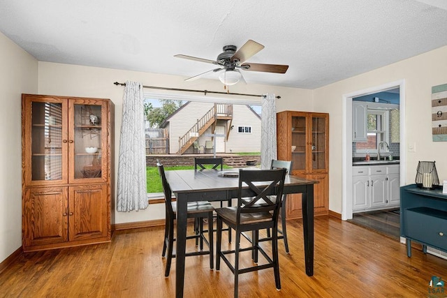 2025 E 8th St, Duluth, MN 55812 - dining space with wood finished floors, ceiling fan, and a textured ceiling