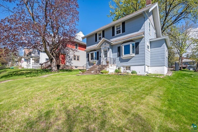 5521 Huntington St, Duluth, MN 55807 - view of front of house with a front yard and a chimney