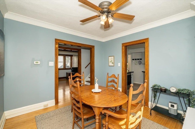 5521 Huntington St, Duluth, MN 55807 - dining space featuring light wood-style floors, ceiling fan, crown molding, and a textured ceiling
