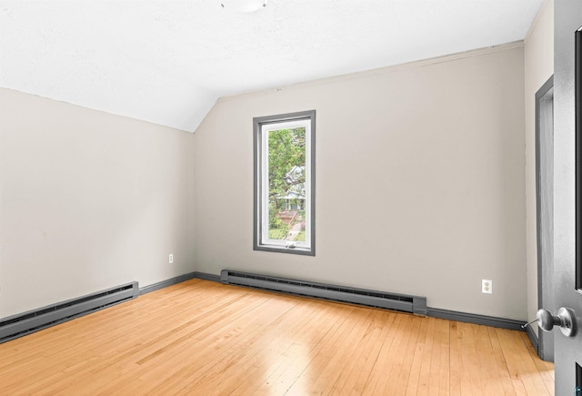 2626 W 5th St, Duluth, MN 55806 - additional living space with a baseboard heating unit, lofted ceiling, and hardwood / wood-style floors