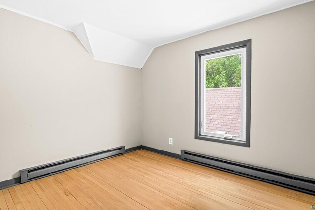 2626 W 5th St, Duluth, MN 55806 - bonus room featuring a baseboard radiator, wood finished floors, and vaulted ceiling