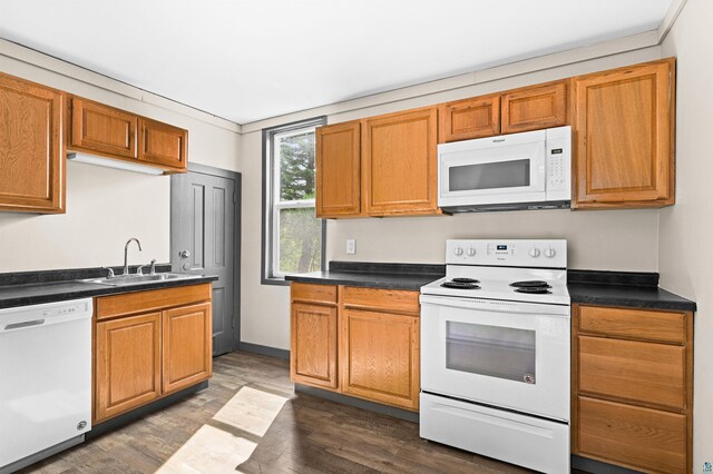 2626 W 5th St, Duluth, MN 55806 - kitchen featuring white appliances, dark wood-style flooring, dark countertops, and brown cabinetry