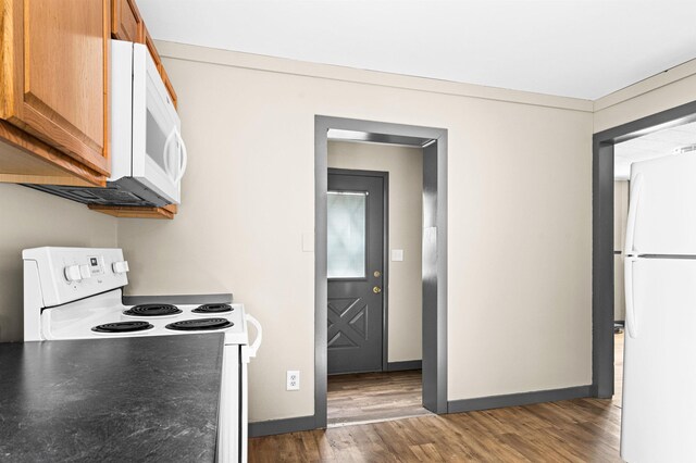 2626 W 5th St, Duluth, MN 55806 - kitchen with white appliances, wood finished floors, and brown cabinets