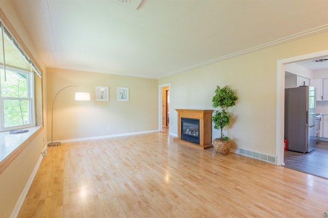 6122 Tacony St, Duluth, MN 55807 - unfurnished living room featuring light wood-style floors and a glass covered fireplace