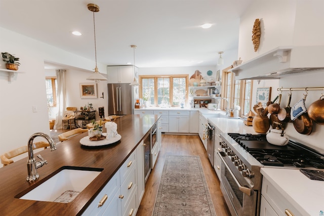 27 Ryan Ln, Esko, MN 55733 - kitchen with premium appliances, light wood-type flooring, butcher block counters, hanging light fixtures, and recessed lighting