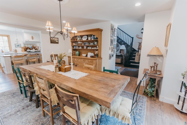 27 Ryan Ln, Esko, MN 55733 - dining room featuring light wood finished floors, a chandelier, recessed lighting, and stairway