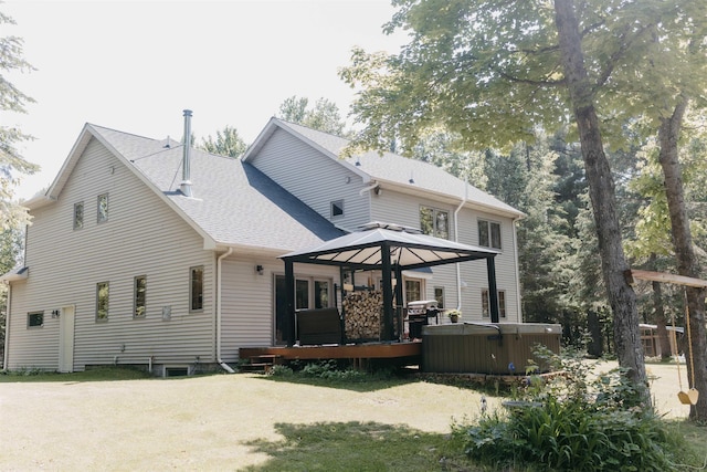 27 Ryan Ln, Esko, MN 55733 - back of house with a hot tub, a gazebo, a wooden deck, and roof with shingles