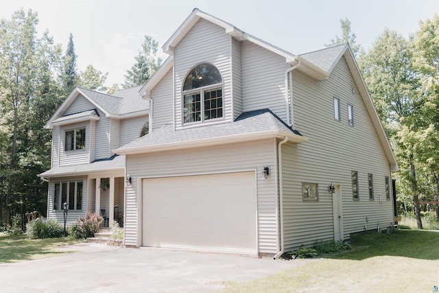 27 Ryan Ln, Esko, MN 55733 - traditional home with a garage, concrete driveway, and roof with shingles