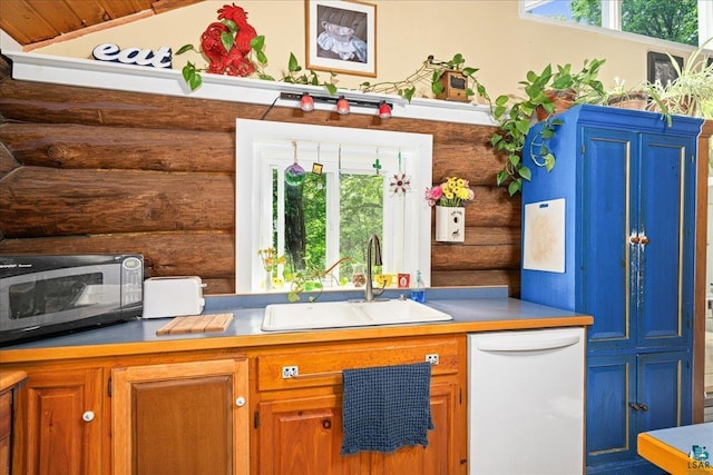 512 Tomberg Rd, Two Harbors, MN 55616 - kitchen featuring log walls, dishwasher, stainless steel microwave, brown cabinetry, and light countertops
