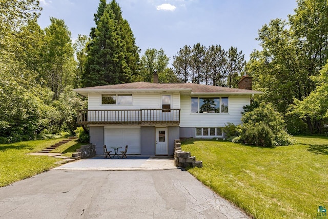 4750 Morris Thomas Rd, Hermantown, MN 55811 - view of front of home with asphalt driveway, a chimney, a front lawn, and an attached garage
