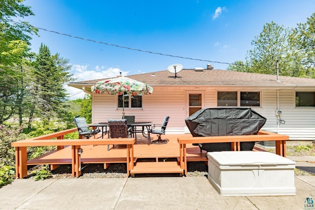 4750 Morris Thomas Rd, Hermantown, MN 55811 - back of property featuring outdoor dining space, a wooden deck, and a shingled roof