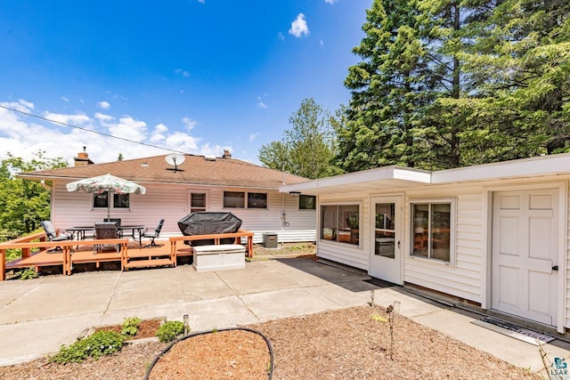 4750 Morris Thomas Rd, Hermantown, MN 55811 - rear view of property featuring a patio area, outdoor dining space, and a chimney