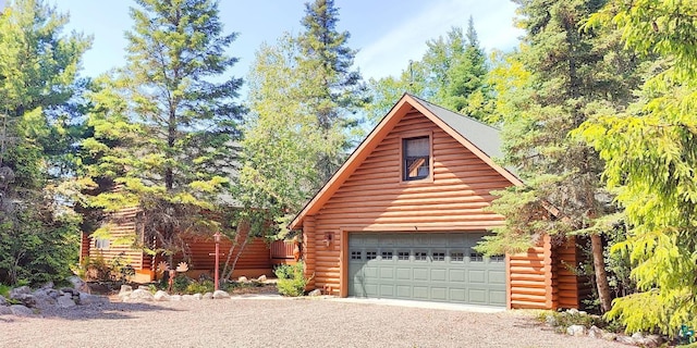 2357 Retreat Lodge Rd, Cook, MN 55723 - view of front facade with log siding, a garage, and an outdoor structure