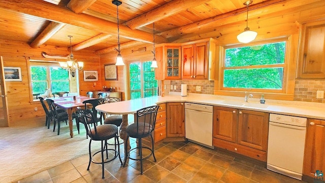 2357 Retreat Lodge Rd, Cook, MN 55723 - kitchen with dishwasher, a wooden ceiling with exposed beams, wooden walls, brown cabinets, and hanging light fixtures