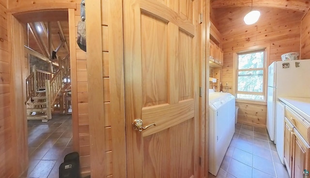 2357 Retreat Lodge Rd, Cook, MN 55723 - washroom featuring washing machine and clothes dryer, wood walls, cabinet space, and tile patterned floors