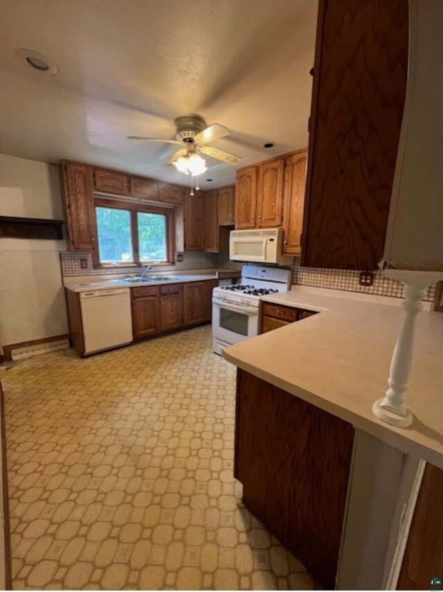 612 23rd St, Cloquet, MN 55720 - kitchen with white appliances, light countertops, a ceiling fan, and brown cabinets