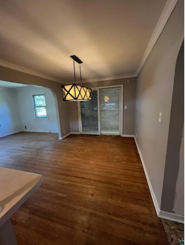 612 23rd St, Cloquet, MN 55720 - unfurnished dining area featuring arched walkways, ornamental molding, and wood finished floors