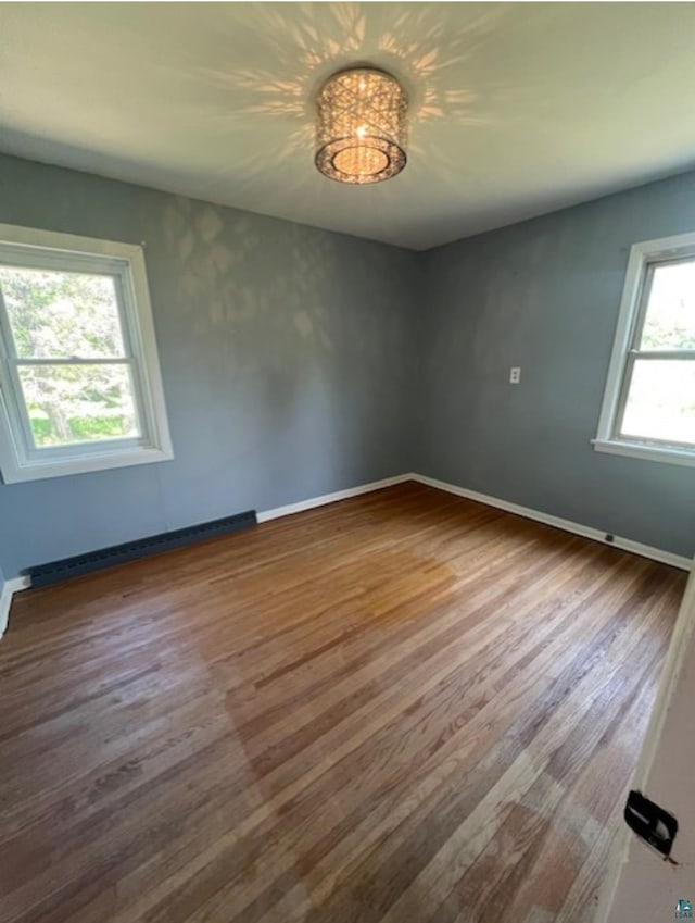 612 23rd St, Cloquet, MN 55720 - unfurnished room with wood finished floors and a baseboard radiator