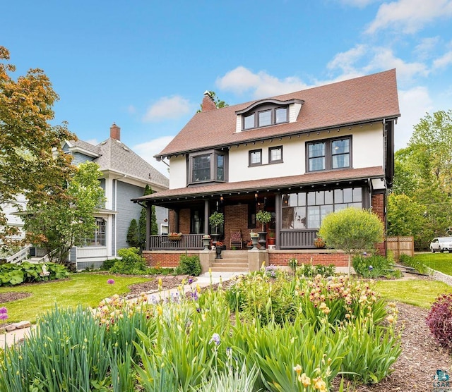 2319 E 4th St, Duluth, MN 55812 - view of front facade with a porch, stucco siding, brick siding, and a chimney