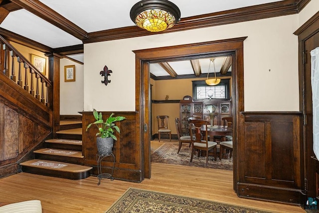 2319 E 4th St, Duluth, MN 55812 - foyer entrance with ornamental molding, stairway, wood finished floors, and wainscoting