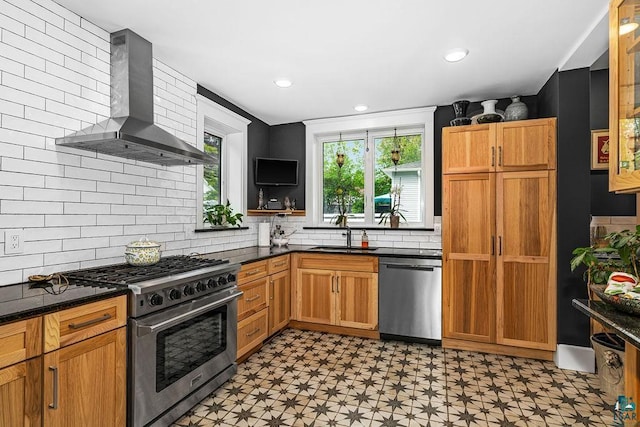 2319 E 4th St, Duluth, MN 55812 - kitchen featuring appliances with stainless steel finishes, wall chimney range hood, light floors, healthy amount of natural light, and recessed lighting