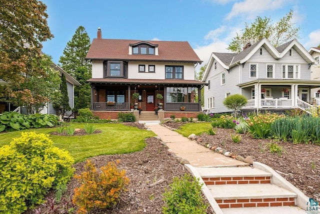 2319 E 4th St, Duluth, MN 55812 - american foursquare style home featuring covered porch, a chimney, and brick siding