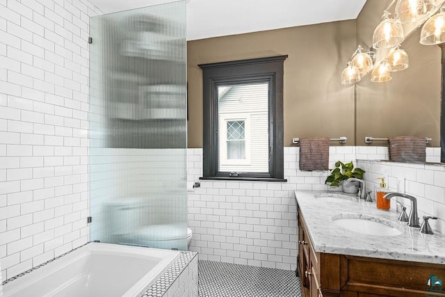 2319 E 4th St, Duluth, MN 55812 - bathroom with double vanity, tile walls, and a chandelier