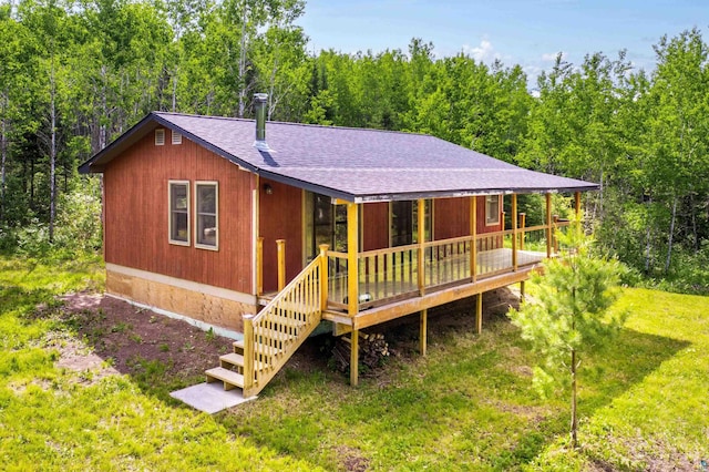 1612 Pequaywan Lake Rd, Ault, MN 55602 - view of front facade featuring roof with shingles, a front yard, and a deck