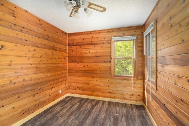1612 Pequaywan Lake Rd, Ault, MN 55602 - empty room with dark wood-style floors, wooden walls, ceiling fan, and a textured ceiling