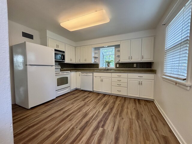 35 E Faribault St, Duluth, MN 55803 - kitchen featuring white appliances, dark countertops, open shelves, dark wood-type flooring, and white cabinetry