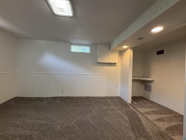 35 E Faribault St, Duluth, MN 55803 - below grade area featuring carpet floors, a textured ceiling, and wainscoting