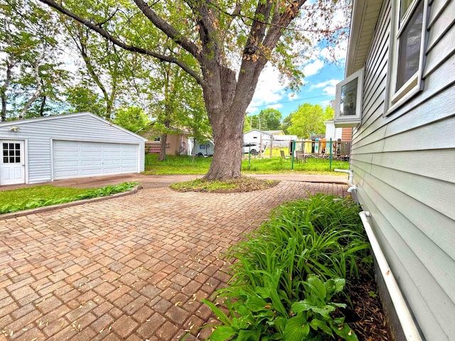 35 E Faribault St, Duluth, MN 55803 - view of patio with a garage and an outbuilding