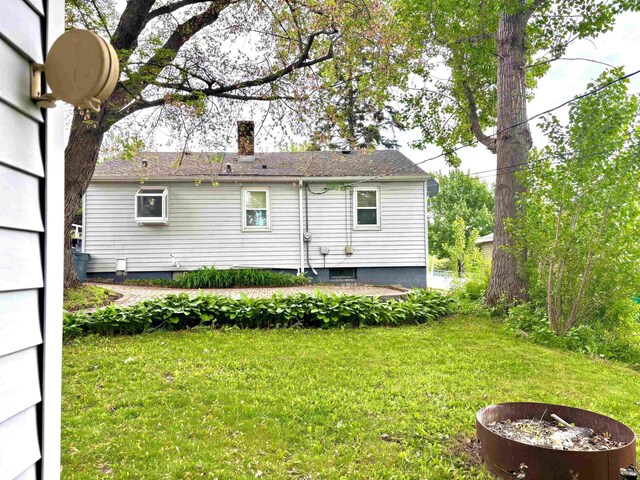 35 E Faribault St, Duluth, MN 55803 - rear view of house with a lawn and a chimney