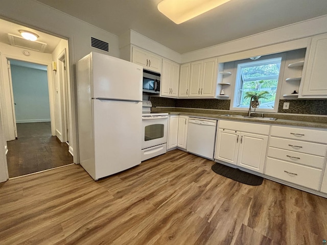 35 E Faribault St, Duluth, MN 55803 - kitchen with white appliances, open shelves, dark countertops, and wood finished floors